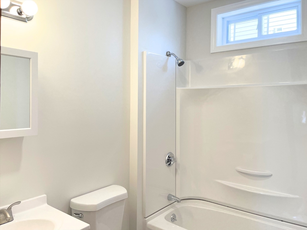 25 Bennett Street, Unit 2 Beverly, MA 01915 - Photo 15 of 17 a bathroom with a toilet and a shower