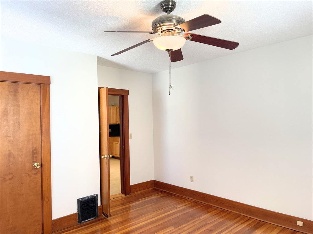 25 Bennett Street, Unit 2 Beverly, MA 01915 - Photo 6 of 17 a view of an empty room with wooden floor