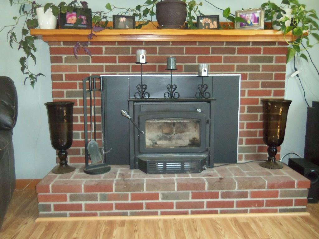 1192 Main Road Eddington, ME 04428 - Photo 5 of 35 lovely brick fireplace with wood...