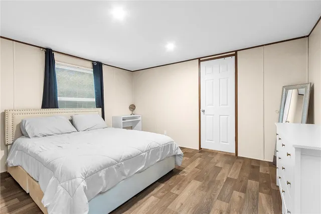 a bedroom with a large bed and a large window