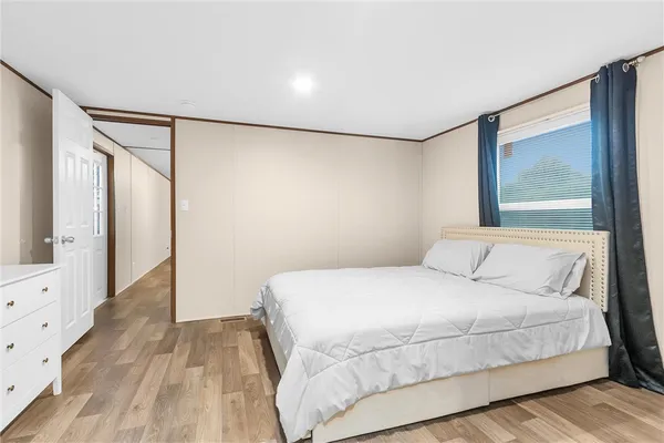 a bedroom with a large bed and a window