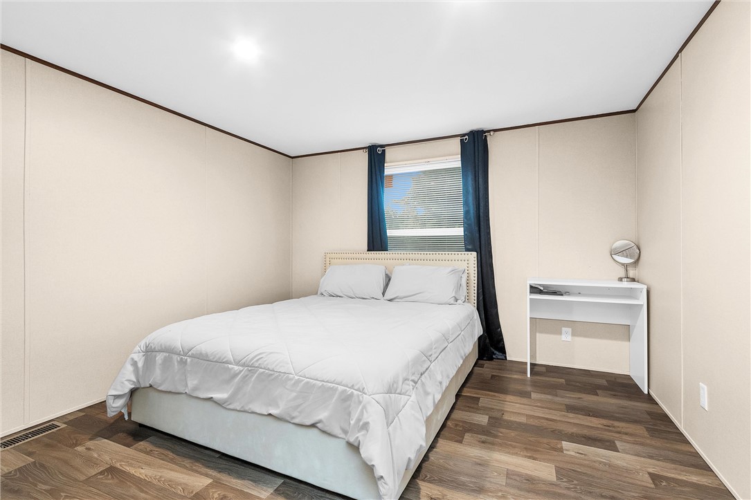 17708 Sweed Road Washington, TX 77880 - Photo 17 of 27 a bedroom with a bed and a night stand