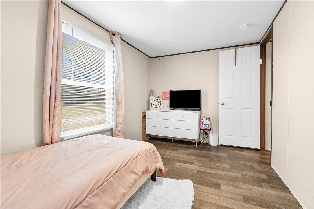 17708 Sweed Road Washington, TX 77880 - Photo 27 of 27 a room with a bed window and a flat screen tv