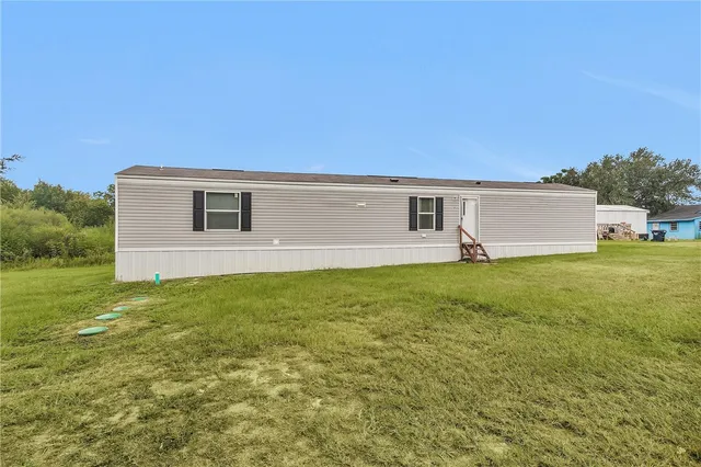 a front view of house with yard and seating area