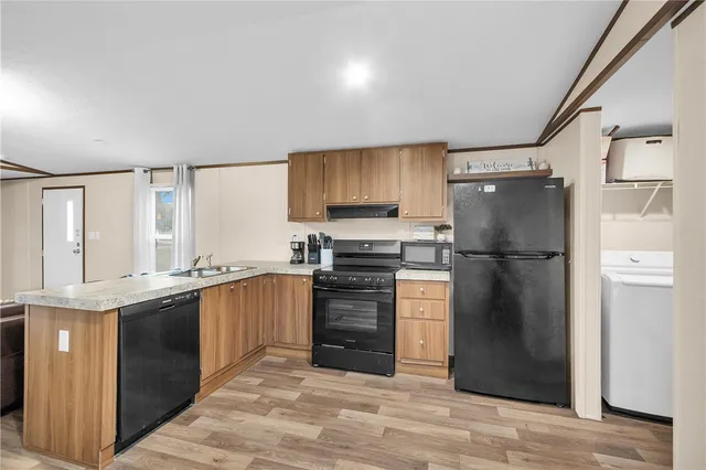 a kitchen with granite countertop a refrigerator stove and sink