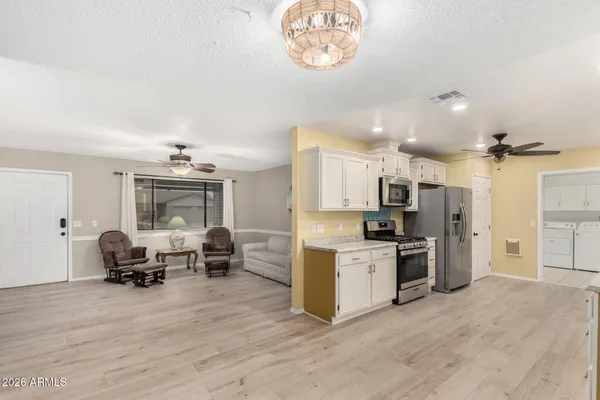 a view of kitchen with sink microwave and refrigerator