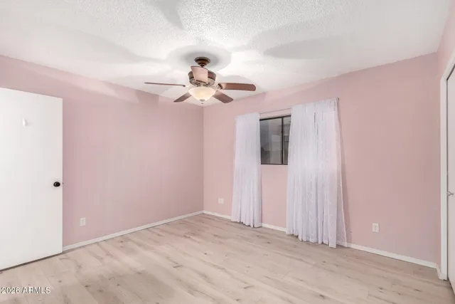 a view of a chandelier fan and entryway