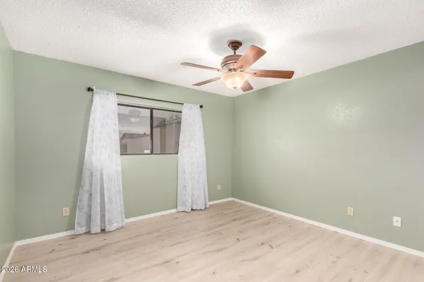 an empty room with fan and a ceiling fan