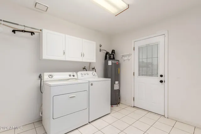 a view of a kitchen with white cabinets and white appliances