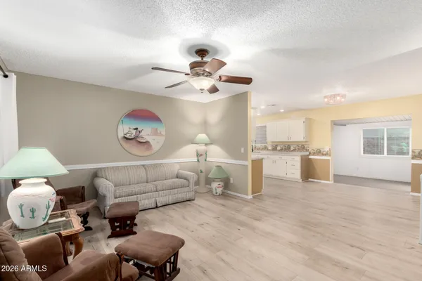 a living room with furniture and kitchen view