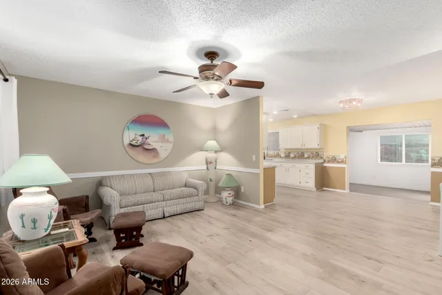 a living room with furniture and kitchen view