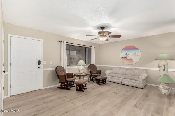 a living room with furniture and a chandelier