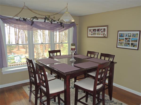 536 Snipatuit Road Rochester, MA 02770 - Photo 4 of 25 a view of a dining room with furniture wooden floor and chandelier