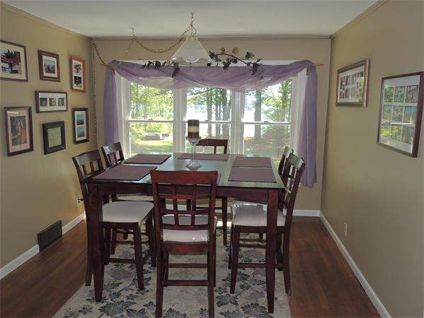 536 Snipatuit Road Rochester, MA 02770 - Photo 5 of 25 a view of a dining room with furniture a chandelier and window