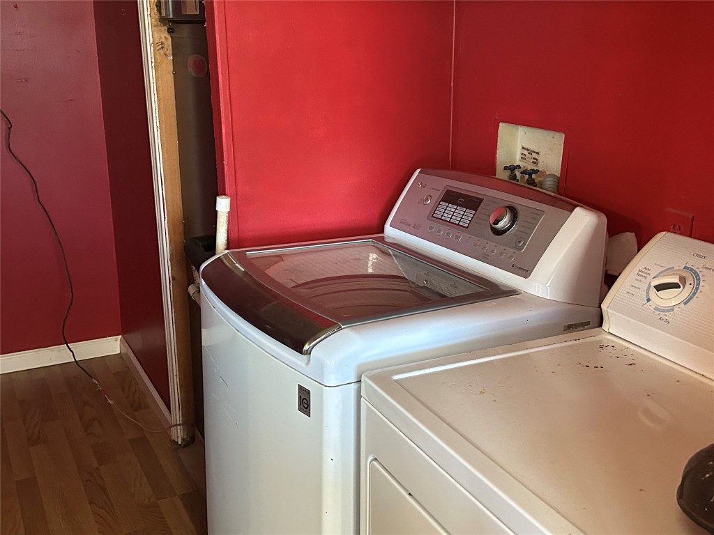 20406 Wilson Road, Unit B Coupland, TX 78615 - Photo 11 of 14 a close up of a utility room with washer and dryer