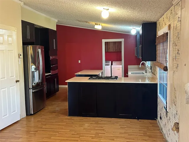 a room with a refrigerator and a sink