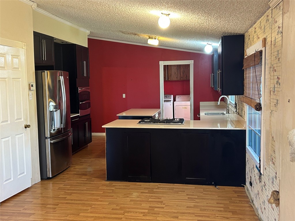 20406 Wilson Road, Unit B Coupland, TX 78615 - Photo 3 of 14 a room with a refrigerator and a sink