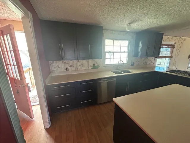 a kitchen that has a sink and a stove in it