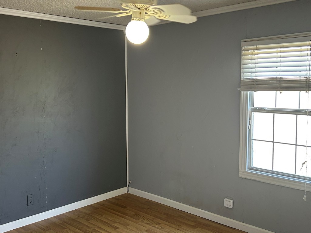20406 Wilson Road, Unit B Coupland, TX 78615 - Photo 8 of 14 an empty room with wooden floor and windows