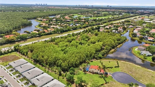 an aerial view of lake residential house with swimming pool and mountain view