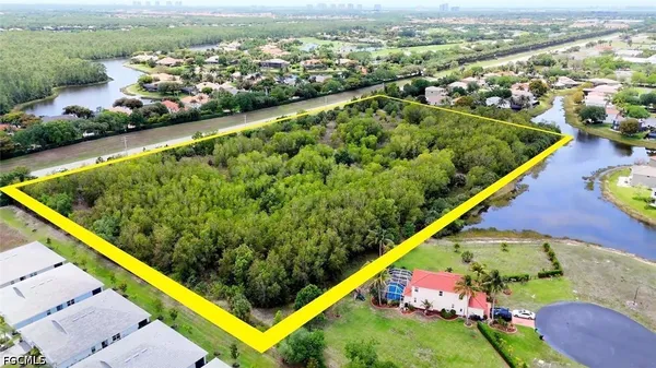 an aerial view of a residential houses with outdoor space and swimming pool