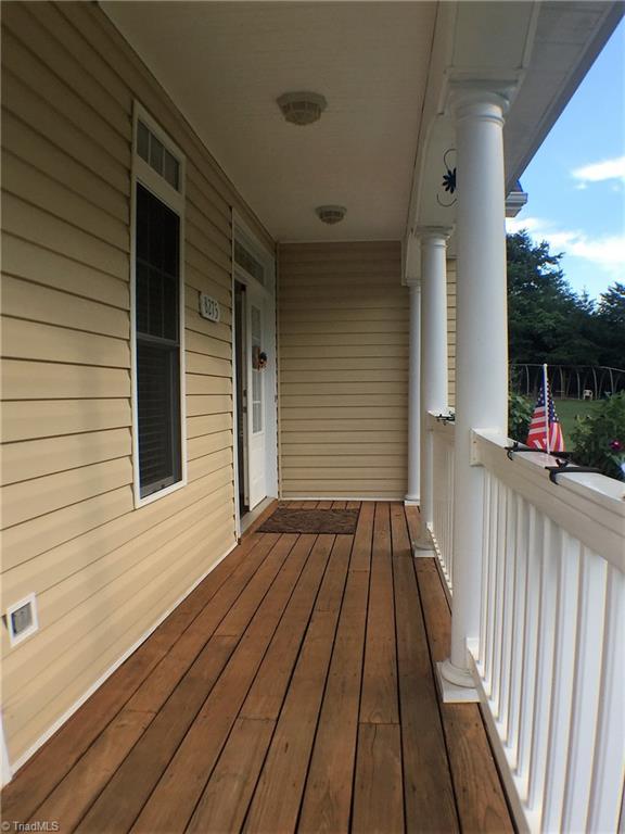 8275 Coldwater Road Stokesdale, NC 27357 - Photo 3 of 30 A portion of the wraparound porch