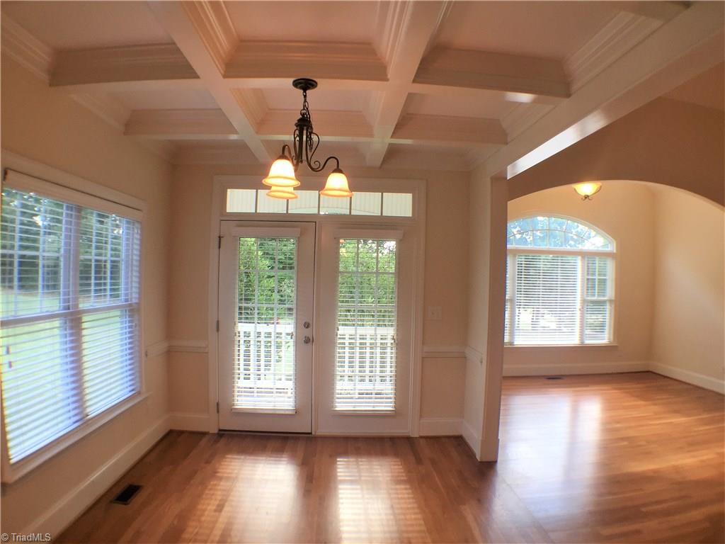 8275 Coldwater Road Stokesdale, NC 27357 - Photo 7 of 30 Dining Room with Coffered Ceiling Leads out to another covered porch