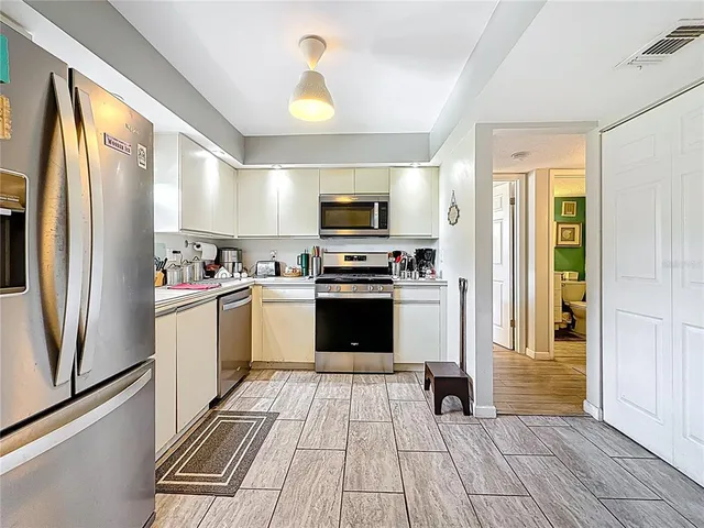 a kitchen with granite countertop a stove and a refrigerator