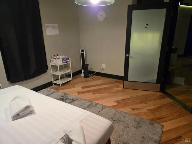 a bedroom with a bed and a chair in it