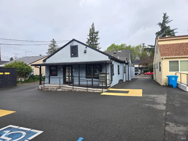 a view of a house with pool and sitting area