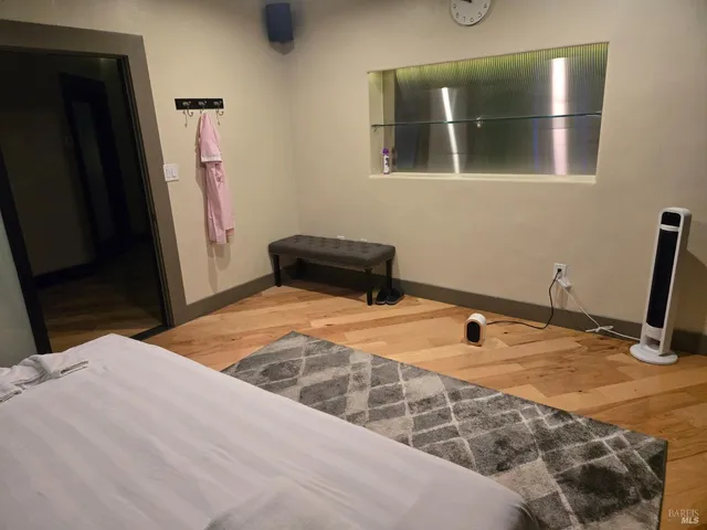 a bedroom with a bed and a mirror