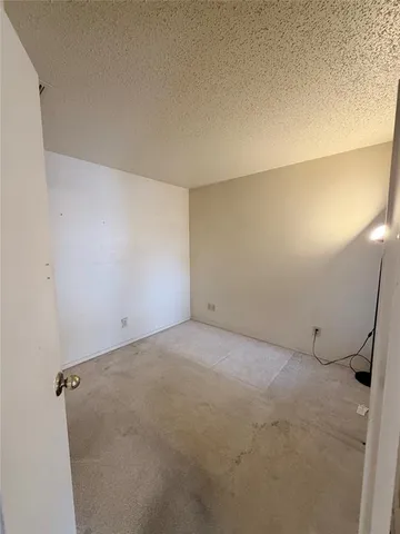 a view of a hallway with a kitchen