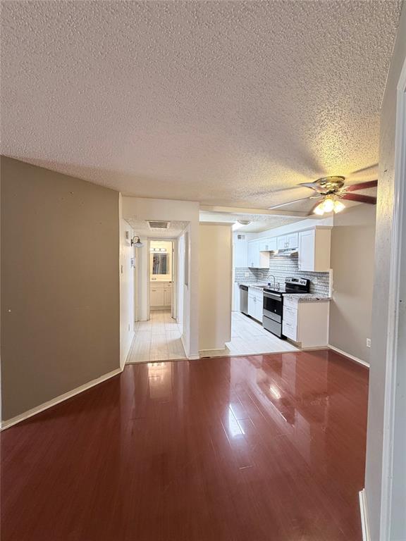 18333 Roehampton Drive, Unit 622 Dallas, TX 75252 - Photo 13 of 28 a view of a kitchen with wooden floor