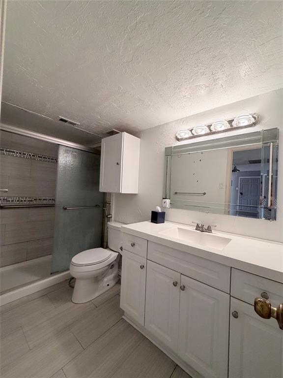 18333 Roehampton Drive, Unit 622 Dallas, TX 75252 - Photo 22 of 28 a spacious bathroom with a toilet sink and mirror