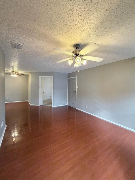 18333 Roehampton Drive, Unit 622 Dallas, TX 75252 - Photo 5 of 28 a view of a livingroom with a ceiling fan and wooden floor