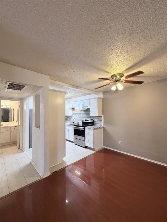 18333 Roehampton Drive, Unit 622 Dallas, TX 75252 - Photo 9 of 28 a view of a kitchen with a sink stove refrigerator and cabinets