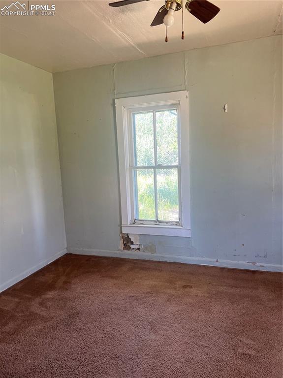 955 Golden Street Calhan, CO 80808 - Photo 8 of 25 an empty room with a window and a ceiling fan