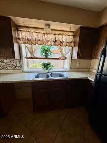 a kitchen with a sink a stove and a microwave