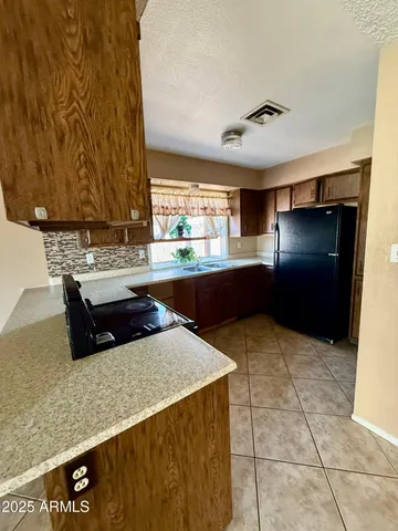 a kitchen with a sink window and cabinets