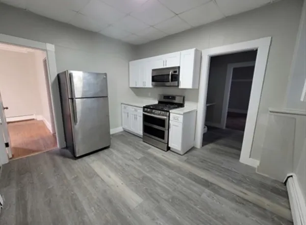 a kitchen with stainless steel appliances a refrigerator sink and microwave