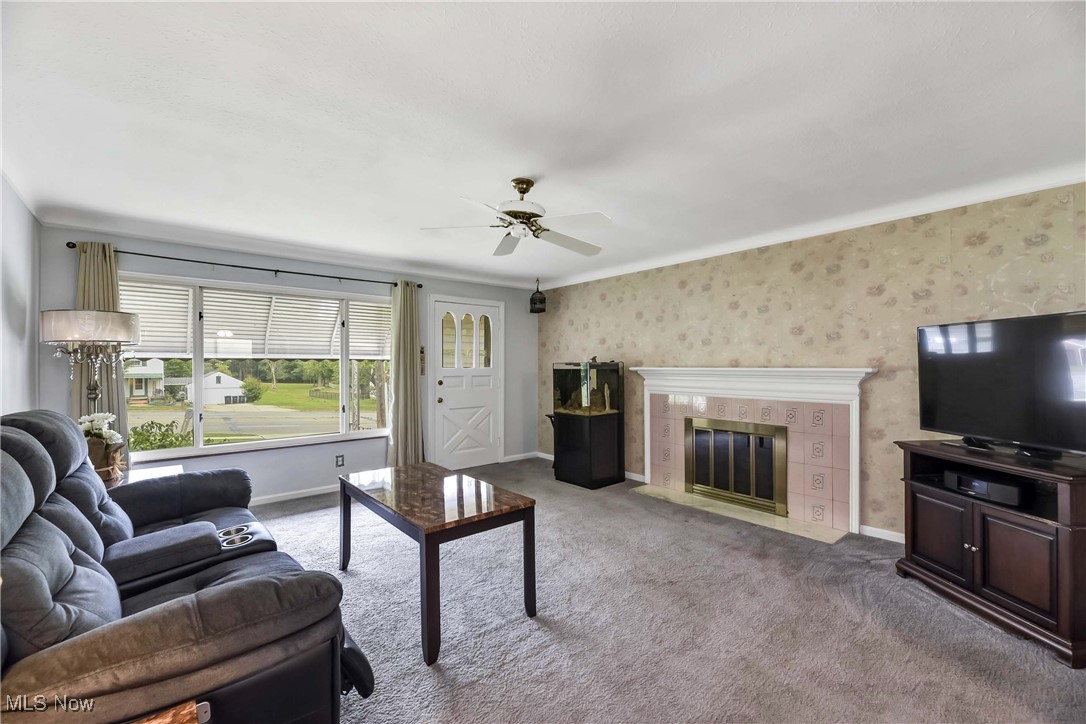 4908 East Pleasant Valley Road Independence, OH 44131 - Photo 2 of 31 Carpeted living room featuring a fireplace and ceiling fan