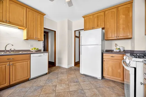 a kitchen with a refrigerator sink stove and cabinets