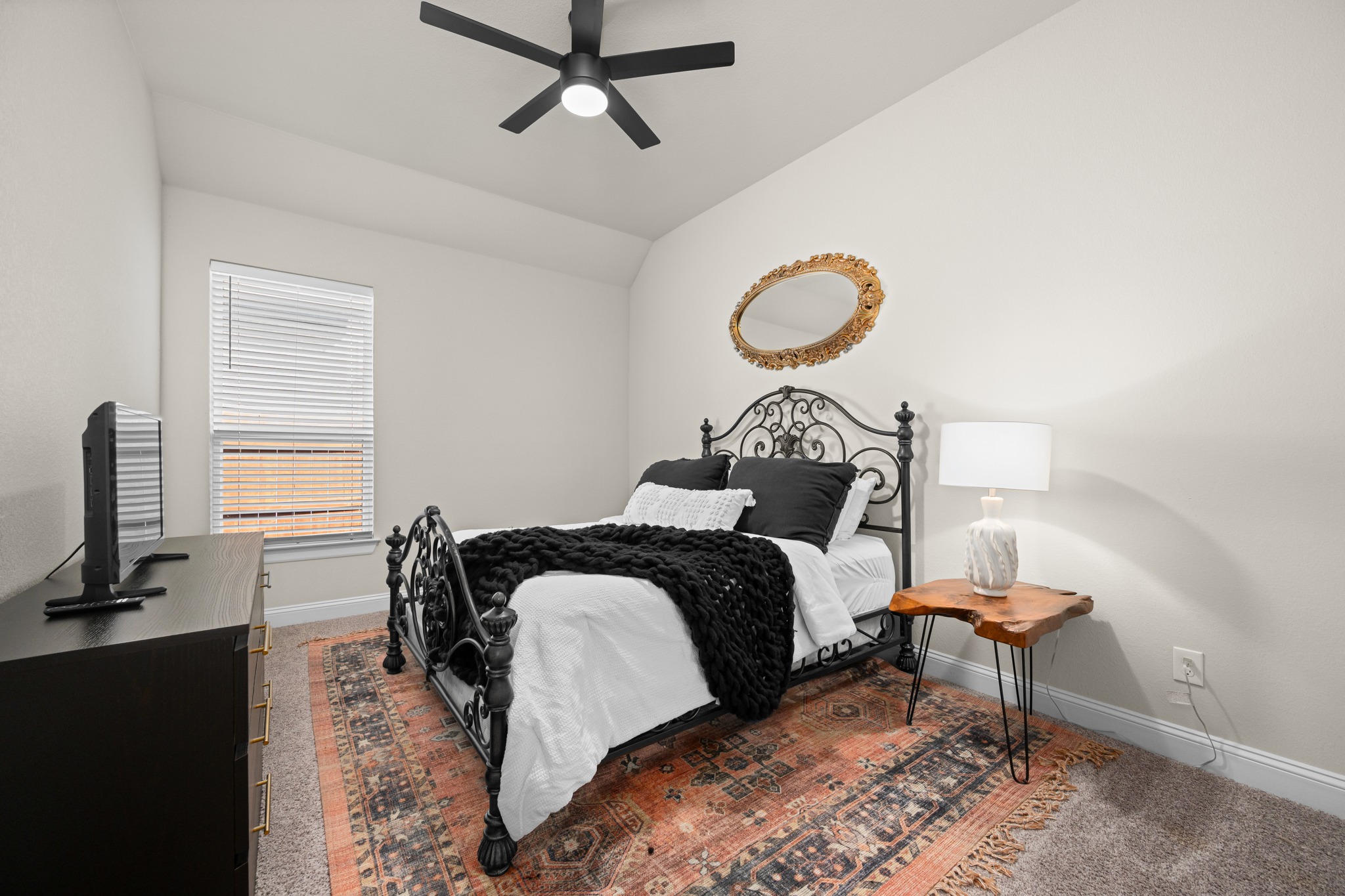 2100 Highland Ridge Road Georgetown, TX 78628 - Photo 22 of 30 A quiet retreat, this bedroom offers vaulted ceilings and a classic wrought iron bed frame.
