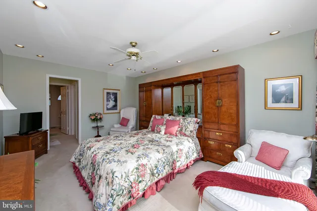 a bedroom with two beds and a dresser