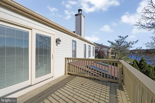 a view of balcony with wooden floor and fence