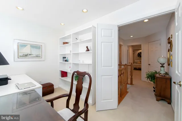 a view of a workspace with furniture and a bedroom