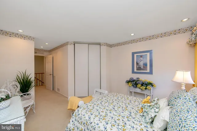 a bedroom with a bed and a potted plant