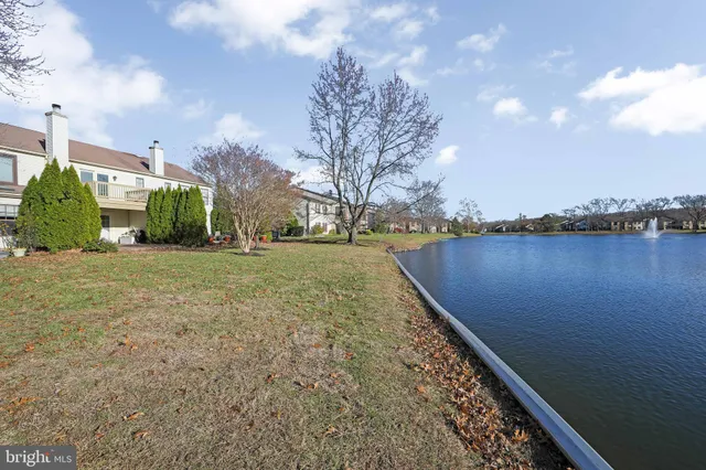 a view of a yard with wooden fence