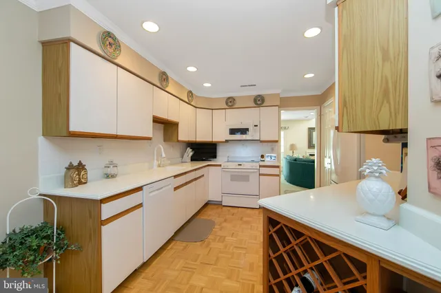 a kitchen with a sink cabinets and wooden floor