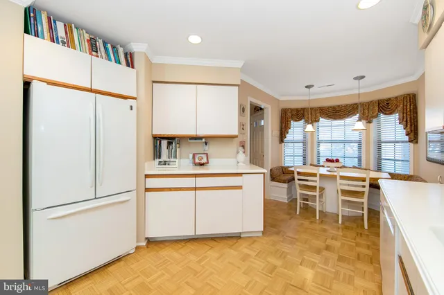 a kitchen with stainless steel appliances a refrigerator and cabinets